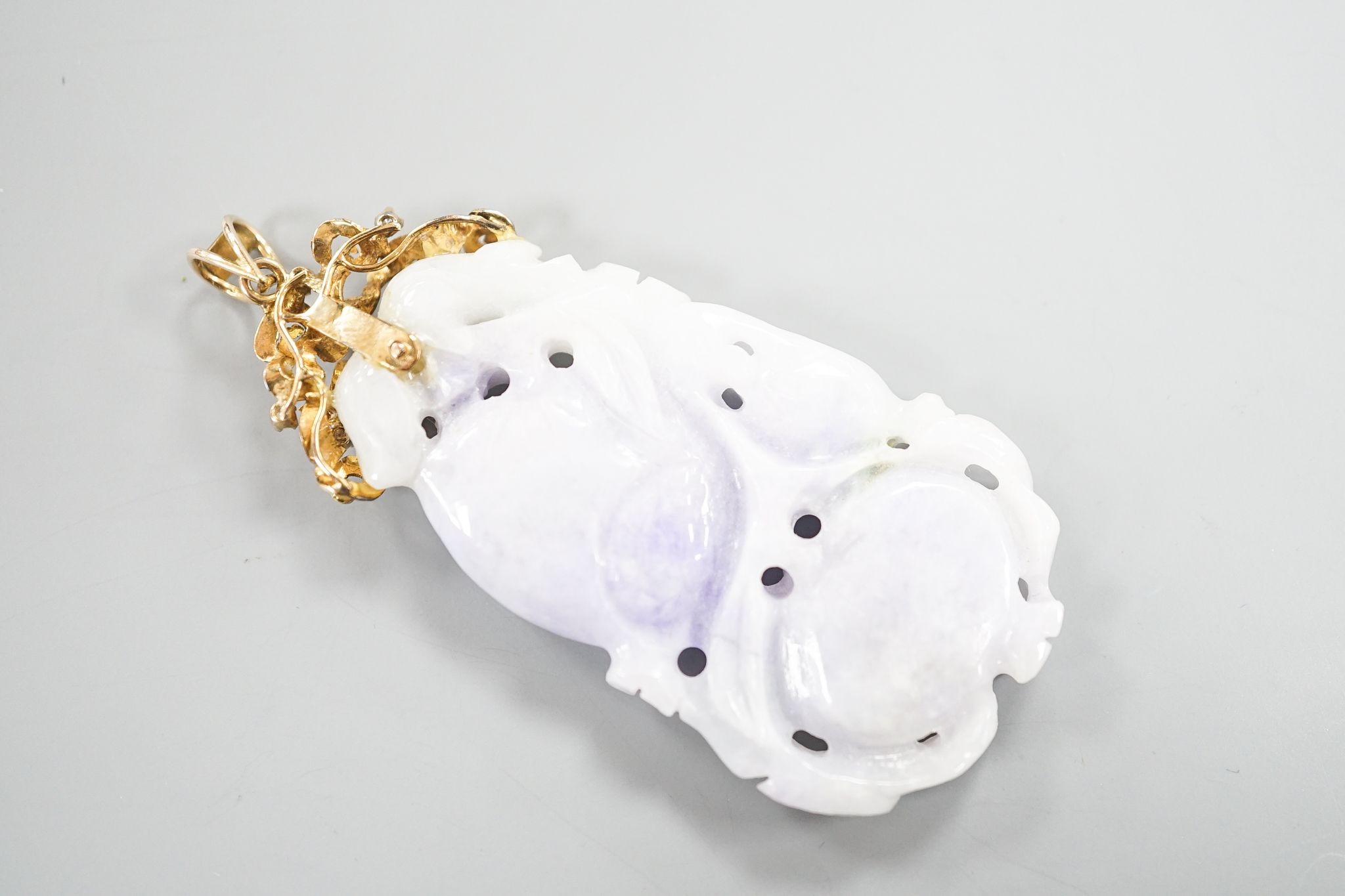 A 14k yellow metal mounted carved jade and diamond chip set pendant, overall 66mm, gross weight 19.4 grams.